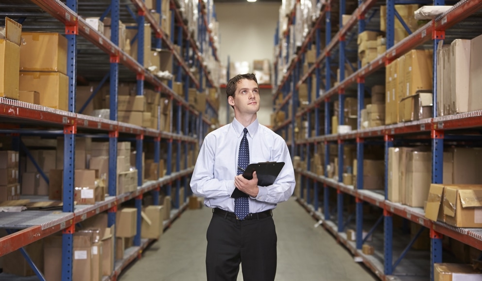 warehouse manager standing in aisle